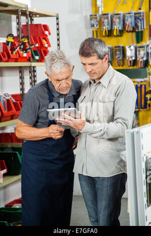 Salesman With Customer Using Digital Tablet Stock Photo