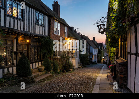 Half timbered Tudor houses on a cobbled street at dusk in Rye, East Sussex Stock Photo