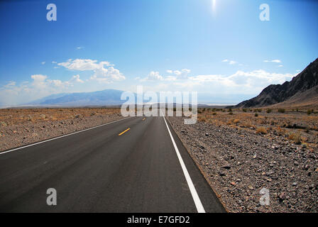 Driving on Death Valley road in the middle of desert landscape Stock Photo