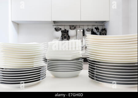 stacks of clean dishes on the kitchen table Stock Photo