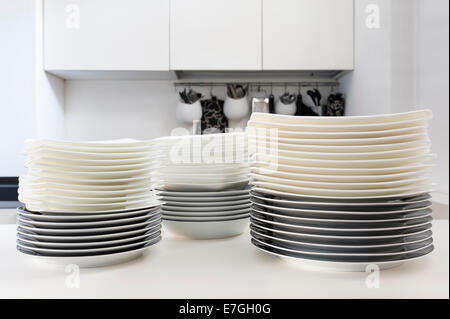 stacks of clean dishes on the kitchen table Stock Photo