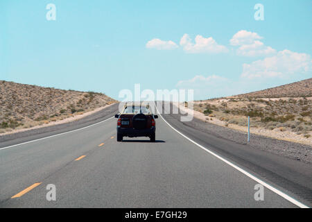 Driving on Death Valley road in the middle of desert landscape Stock Photo