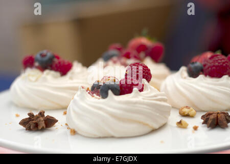 A selection of fruit topped meringues Stock Photo