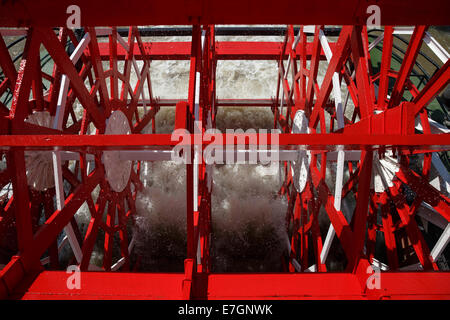 Red paddlewheel powering an old steamboat / paddleboat on the Mississippi River. Stock Photo