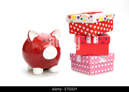 Red piggy bank and gift boxes on the white background Stock Photo