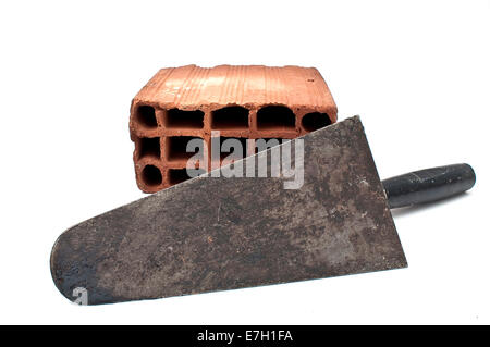 Brick and trowel isolated on white background. Stock Photo