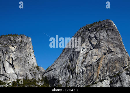 Granite dome of Liberty Cap, and jet contrail, on The Mist Trail, Yosemite National Park, California, USA Stock Photo