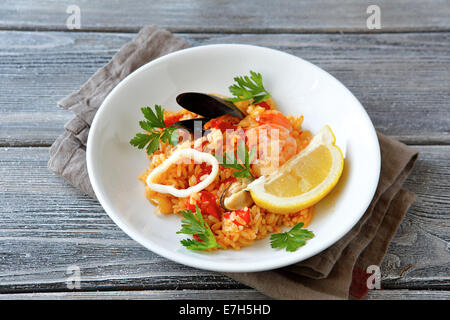 Tasty risotto with mussels and vegetables meat plate, top view Stock Photo