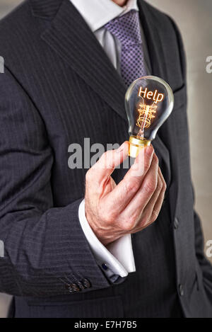Help concept in a filament lightbulb. Stock Photo