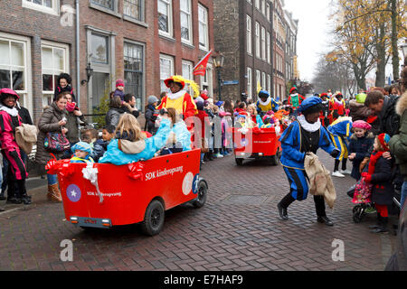 DORDRECHT, THE NETHERLANDS - NOVEMBER 17: Children being driven in carts escorted by Zwarte Piet dressed in costume Stock Photo