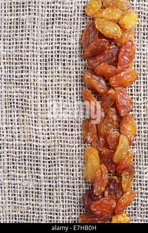 Raisins on burlap background closeup Stock Photo