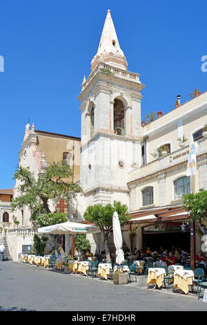 People sitting in the shade at Taormina café restaurant on a hot summers day Corso Umberto Taormina Province of Messina Sicily Italy Stock Photo