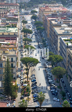 Naples street looking down on wide long straight tree lined road with four lines of parked cars Stock Photo
