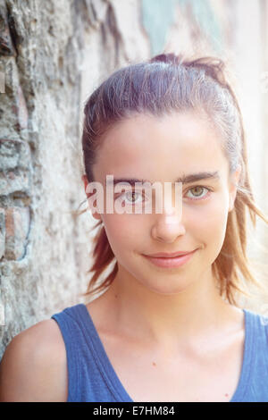 portrait of a beautiful teenager girl leaning against a wall. portrait of a beautiful teenager girl leaning against a wall.