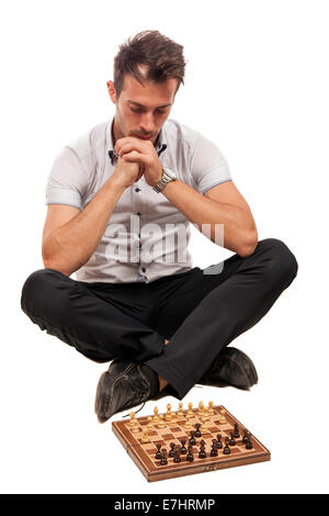 Serious focused man thinks on game of chess isolated on white Stock Photo