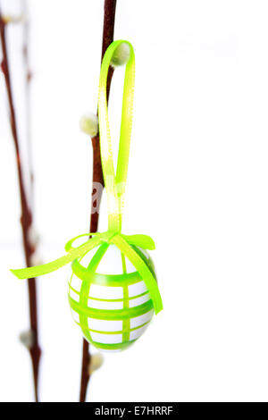 Easter egg individually hanging on a branch with white background Stock Photo