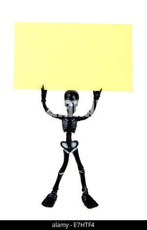 Funny skeleton holding a yellow post it isolated on white Stock Photo