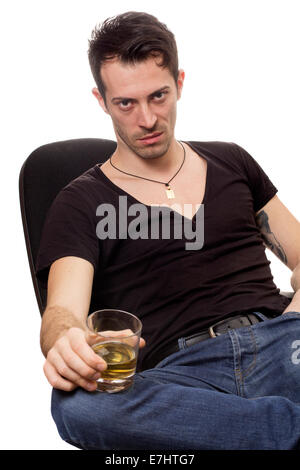 Portrait of young man with glass of cognac over white background Stock Photo