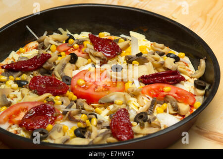 Close-up of vegetarian unprepared pizza with tomatoes, mushrooms and meat Stock Photo