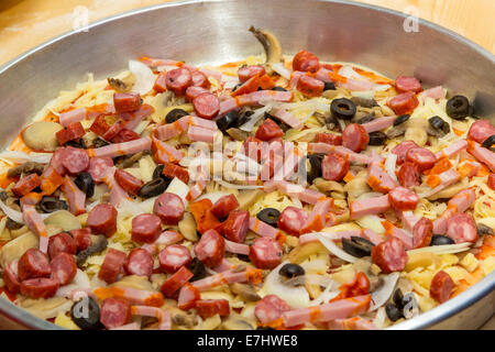 Close-up of unprepared pizza with tomatoes, mushrooms and meat Stock Photo