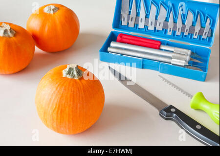 Mini Halloween pumpkins with carving tools Stock Photo