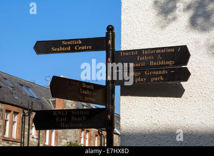 A traditional sign post giving directions to various attractions in North Berwick, Scotland. Stock Photo