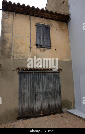 charming picturesque, pastel/sorbet colored houses with contrasting shutters, quaint, terracotta roofs with contrasting shutters Stock Photo