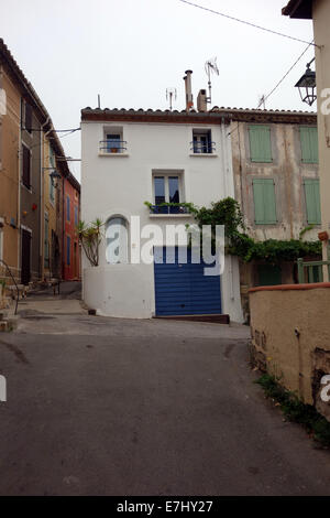 charming picturesque, pastel/sorbet colored houses with contrasting shutters, quaint, terracotta roofs with contrasting shutters Stock Photo