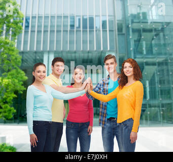 smiling teenagers making high five Stock Photo