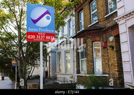 A real estate sign To Let outside terraced houses in South London England United Kingdom UK Stock Photo