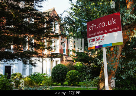 A real estate sign For Sale outside terraced houses in South London England United Kingdom UK Stock Photo