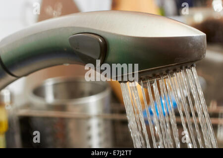 Water running from a kitchen faucet Stock Photo