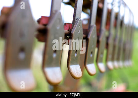 A rusty plough in corner of a West Sussex Field. Picture by Julie Edwards Stock Photo