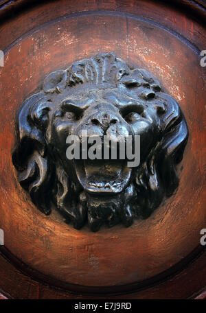 Antique door knocker in the form of a lion's head on old wooden door, Rome, Italy Stock Photo