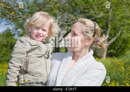 mother holding son in her arms Stock Photo - Alamy