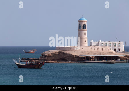 Dhow-ship in front of a lighthouse, Al Ayjah, Sur, Ash Sharqiyah province, Sultanate of Oman, Arabian Peninsula Stock Photo