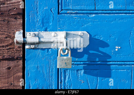 Padlock on Rustic Blue Boat Shed Door, Lindisfarne or Holy Island, Northumberland, England, UK Stock Photo
