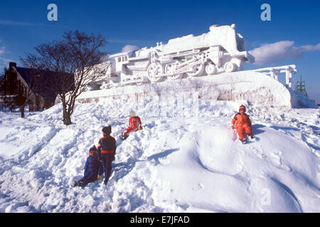 Children Playing at Snow Sculpture, Sapporo, Japan Stock Photo