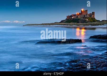 Bamburgh Castle from Harkess Rocks at Dusk, Bamburgh, Northumberland, England, UK Stock Photo