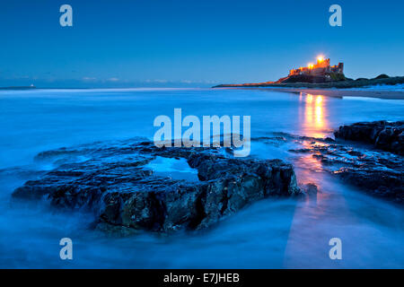 Bamburgh Castle from Harkess Rocks at Dusk, Bamburgh, Northumberland, England, UK Stock Photo