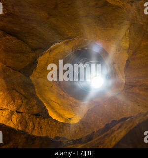 Mysterious dungeon- tunnel with walls made of stone Stock Photo