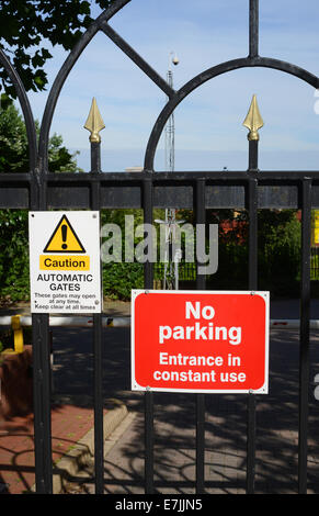 no parking notice in front of locked gates to offices and apartments in leeds yorkshire united kingdom Stock Photo