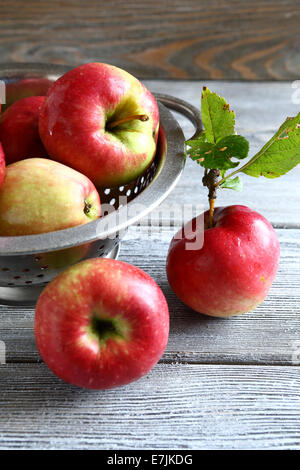 Fresh apples in a metal colander, food closeup Stock Photo