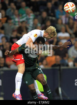 Salzburg, Austria. 18th Sep, 2014.Salzburg's Martin Hinteregger (l) vies for the ball with Celtic's Efe Ambrose during the Europa League soccer match between Red Bull Salzburg vs FC Celtic Glasgow in Salzburg, Austria, 18 September 2014. Credit:  dpa picture alliance/Alamy Live News Stock Photo