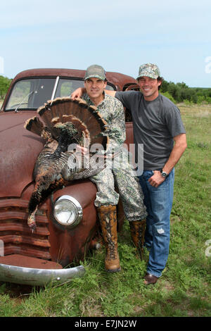 Texas Governor Rick Perry poses with country music star Clay Walker after they shot a turkey while bow hunting at the Vinson Ranch May 22, 2006 in Albany, Texas. Stock Photo