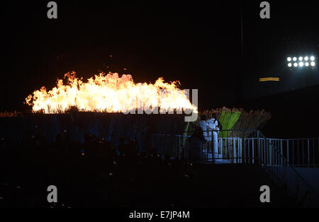 Incheon, South Korea. 19th Sep, 2014. South Korean actress Lee Young-ae (C) and two children light up the cauldron of the 17th Asian Games during the opening ceremony of the 17th Asian Games at the Incheon Asiad Main Stadium in Incheon, South Korea, Sept. 19, 2014. Credit:  Gong Lei/Xinhua/Alamy Live News Stock Photo