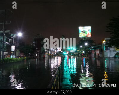 Manila, Philippines. 19 September, 2014. Almost one kilometer of Espana Blvd. is flooded and mostly not passable due to gutter deep flood waters brought by Tropical Storm Fung Wong which is locally known as Mario. Some vehicles and stranded passengers took the guts to traverse the horrendous flood waters along the stretch of Espana Blvd. Its estimated rainfall amount is from 7 – 20 mm per hour(moderate to intense) within the stropical storm’s 350 km diameter. Credit:  Sherbien Dacalanio / Alamy Live News Stock Photo