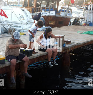 Family fishing on jetty Stock Photo