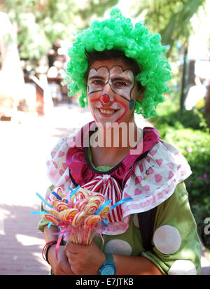 Female lolly seller in clown dress Stock Photo