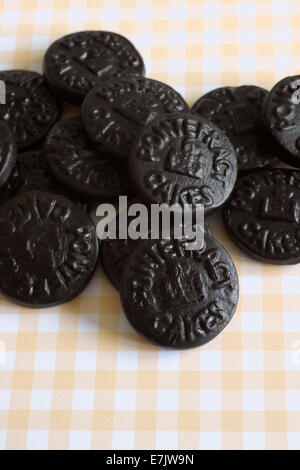 Pontefract Cakes a licorice sweet from Yorkshire stamped with the castle lodge emblem a traditional design dated to 1612 Stock Photo